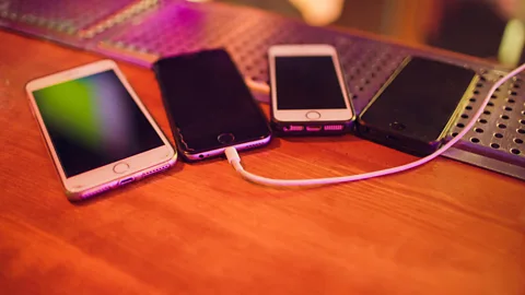 Alamy 'Phone farming' is one approach people are trying to make passive income (Credit: Alamy)