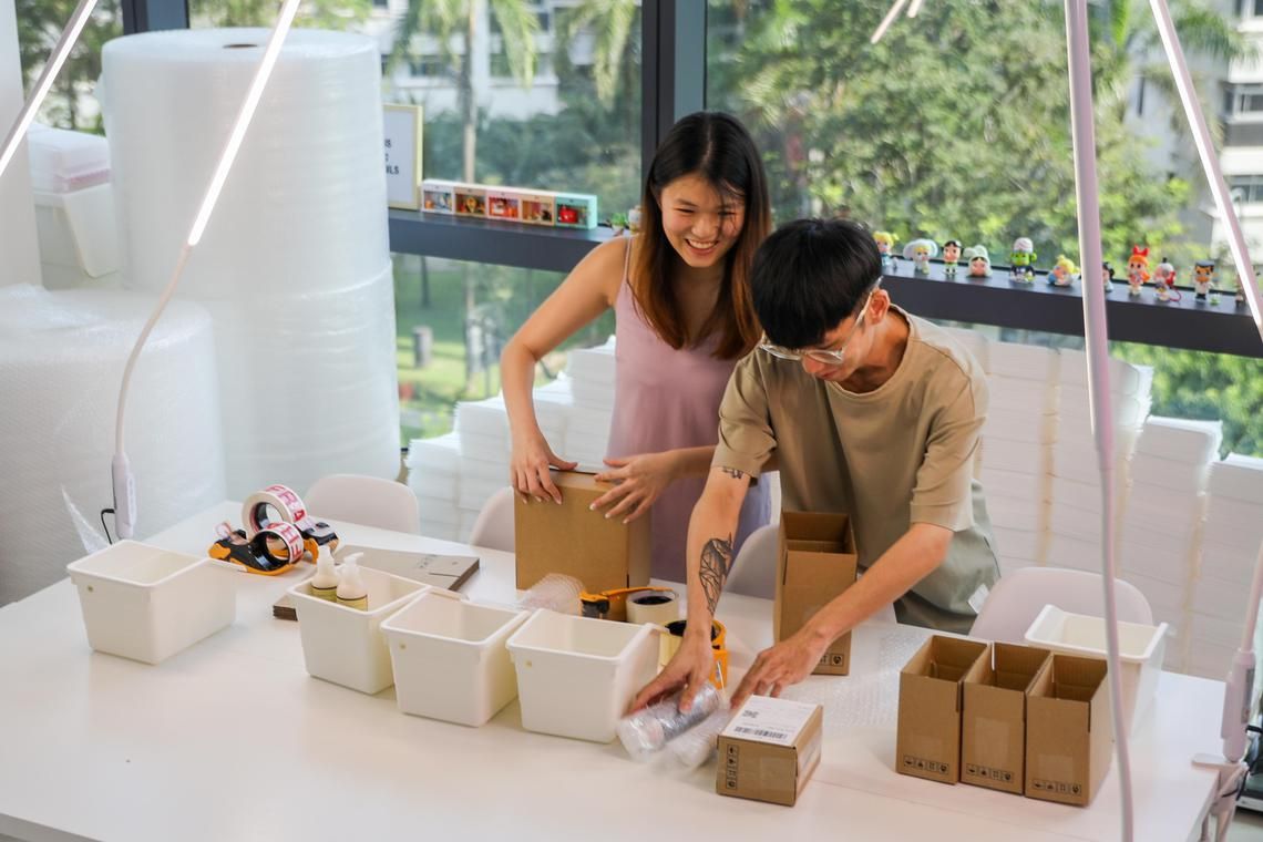 ST20240905_202423200653/ssmillion28/Luther Lau/Sarah R Stanley/
Shots of Winnie Yong, 22, (Left) and Kermond Koh, 23, (Right) packing their products to be sent out to customers. Taken at 10 Woodlands Square Solo 1.
